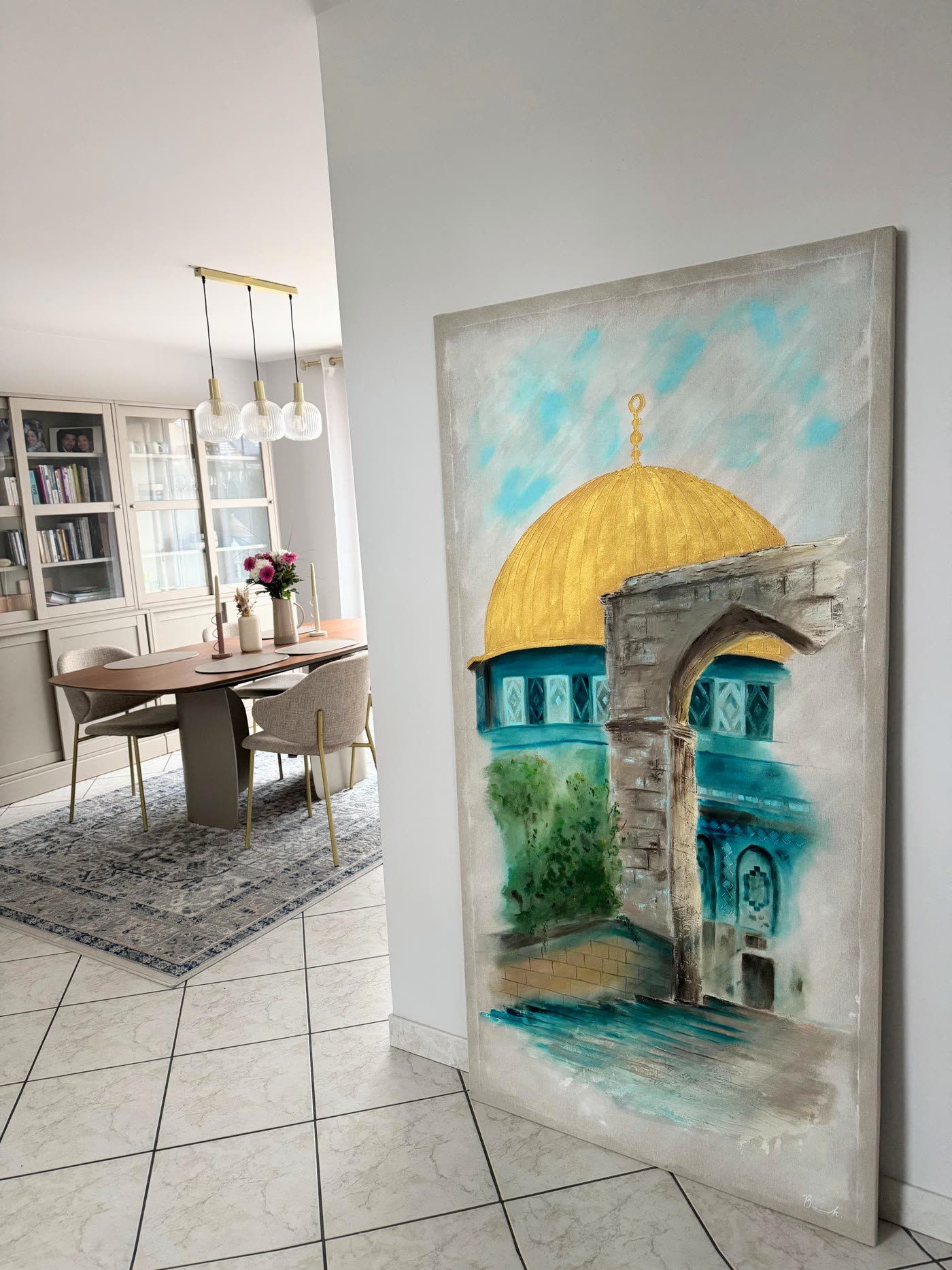 Al Aqsa standing against a wall in a hallway, the gold dome catching the daylight, a dining room visible beyond.