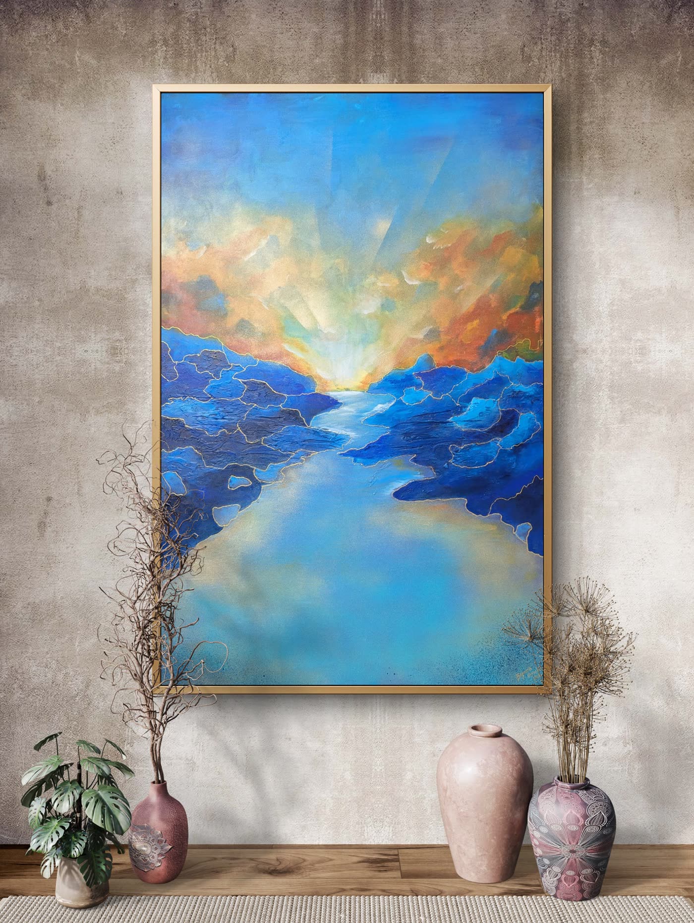 A large painting hanging in a warm interior above dried flowers and ceramic vases.