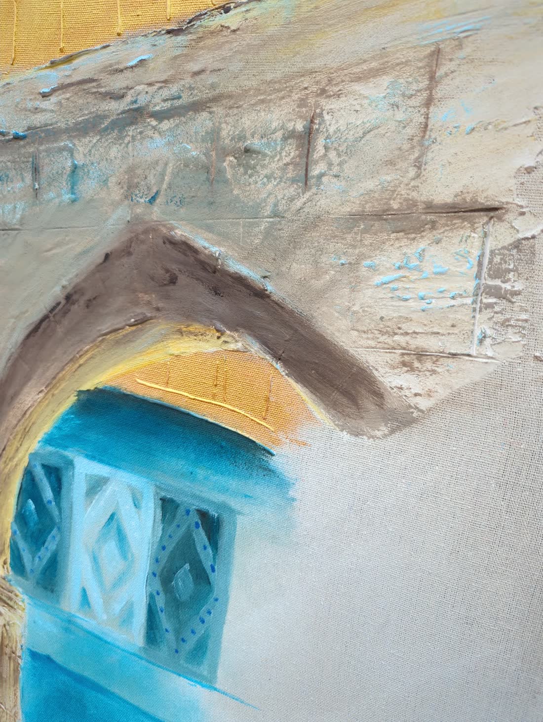 Detail: the gold dome meeting the stone arch, both built out in relief.