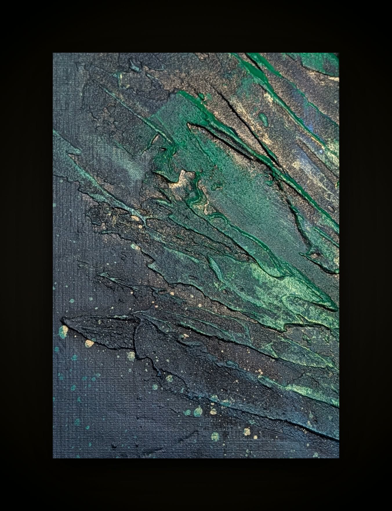 Dark ground with green and gold ridges and a scatter of pale dots.