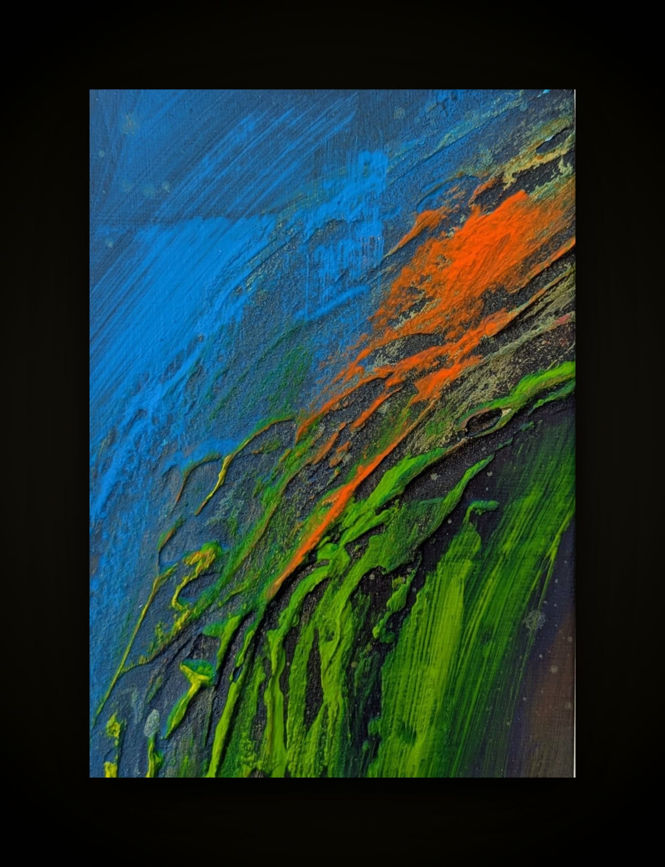 A blue field cut by a ridge of orange and vivid green running diagonally.