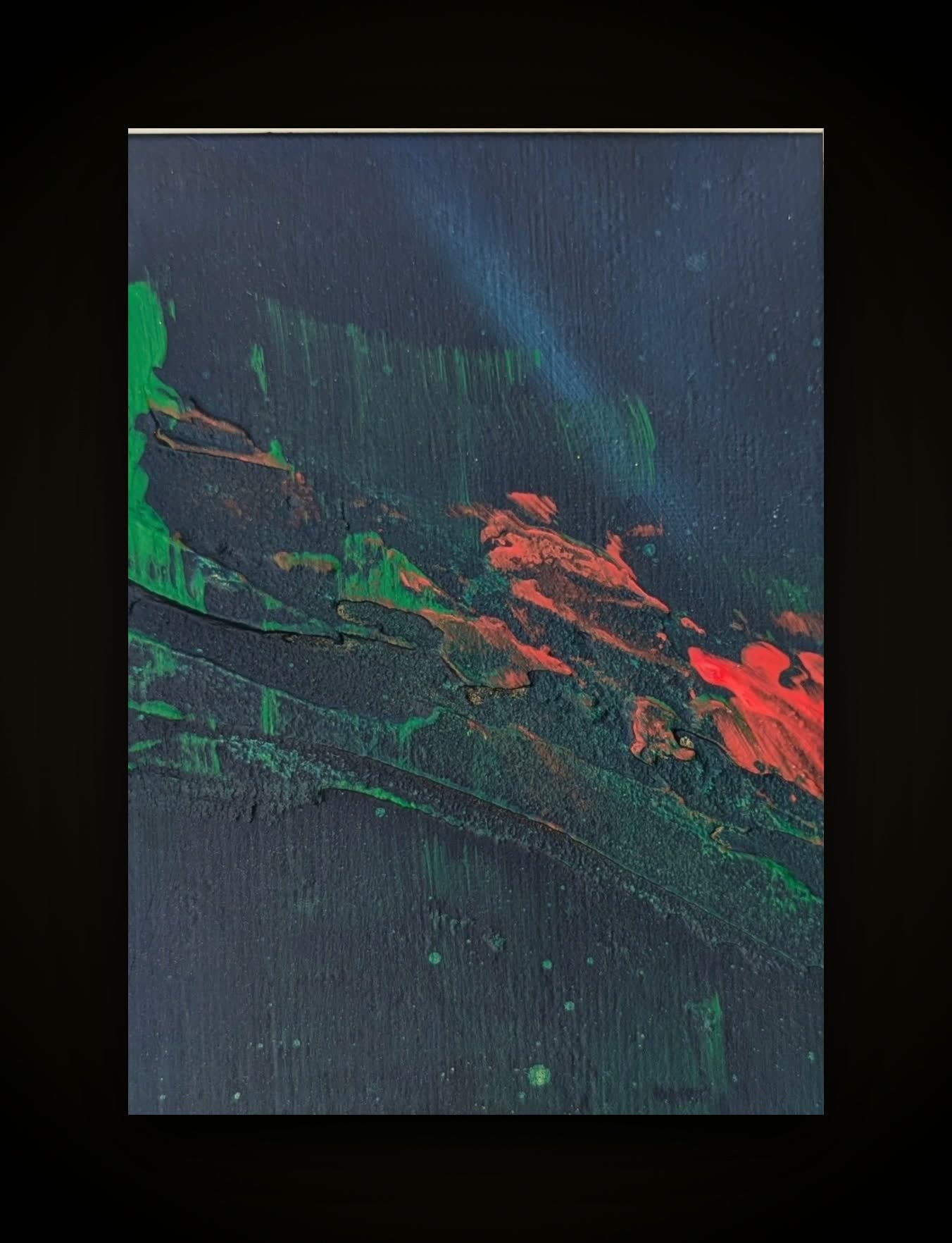 Dark ground with a green form at the left and red streaks running across it.