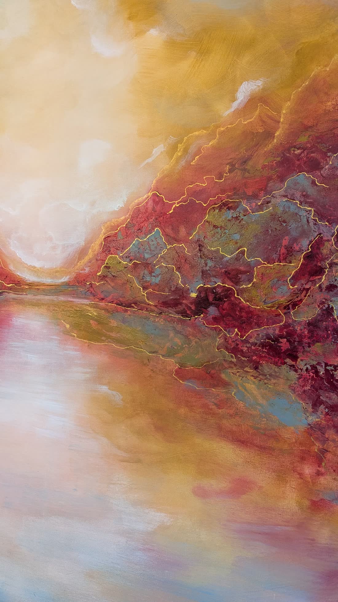 Detail: crimson and gold seams running through the relief.